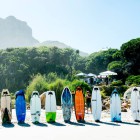 The weird shaped surfboards on the beach ready and waiting