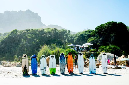 The weird shaped surfboards on the beach ready and waiting