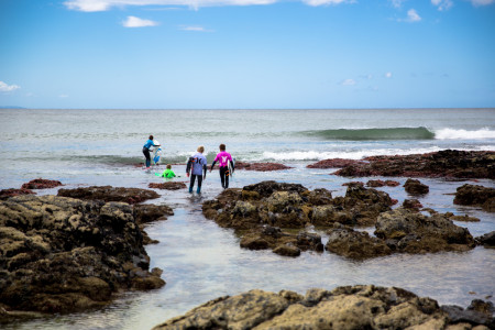 Junior surfing competitors in the water at the SA champs