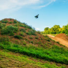 Motocross riders hitting the MTB jumps at Loosefest 2017